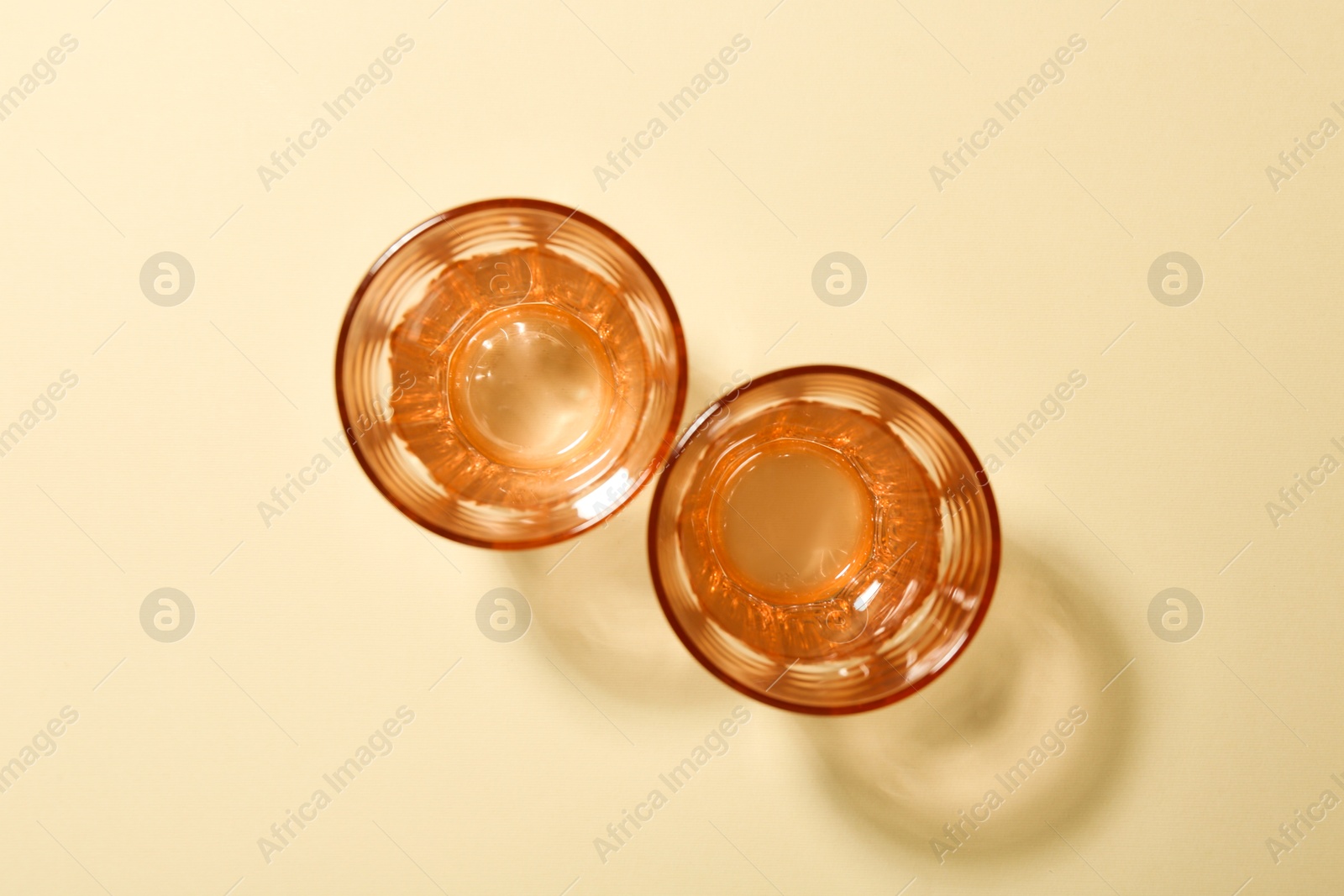 Photo of Empty glass vases on beige background, flat lay