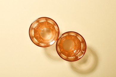 Photo of Empty glass vases on beige background, flat lay