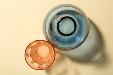 Photo of Empty glass vases on beige background, flat lay