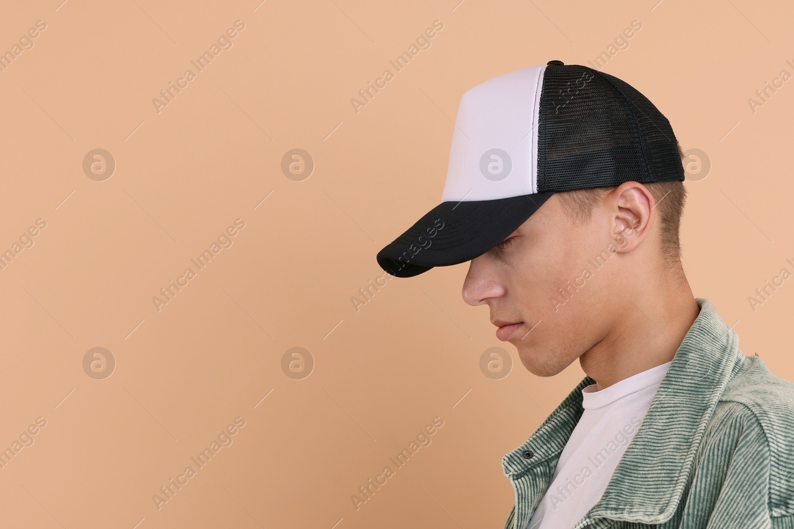 Photo of Man in stylish baseball cap on beige background. Mockup for design