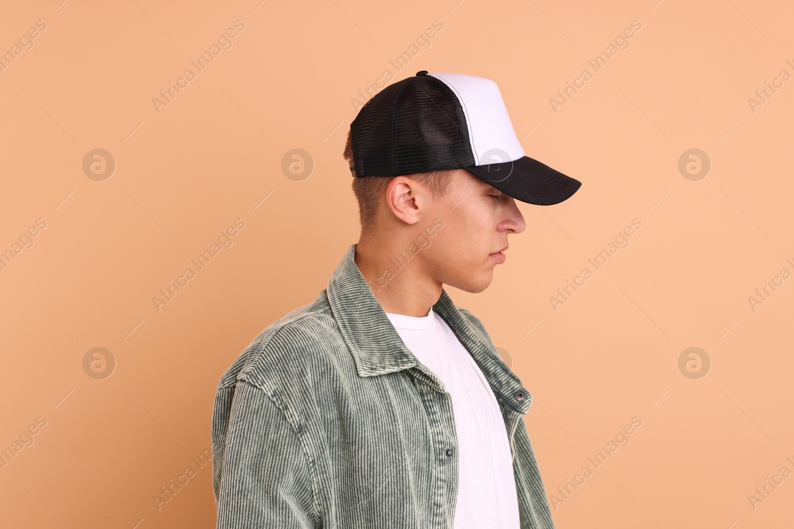 Photo of Man in stylish baseball cap on beige background. Mockup for design