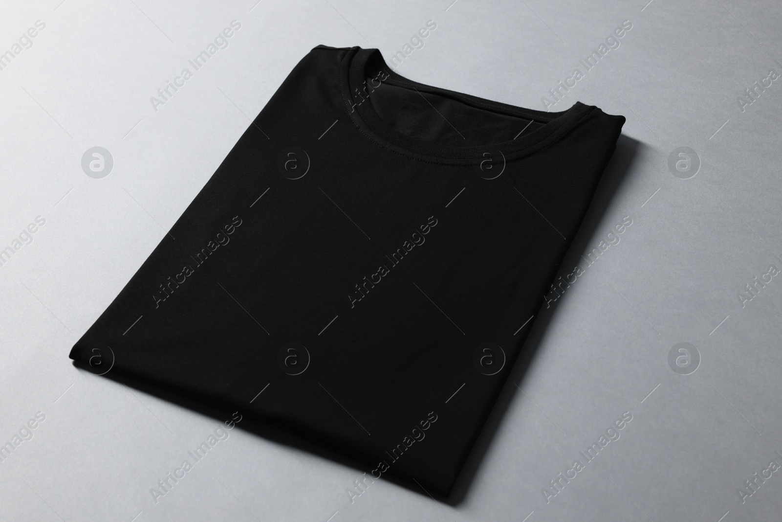 Photo of Blank black t-shirt on grey background. Mockup for design