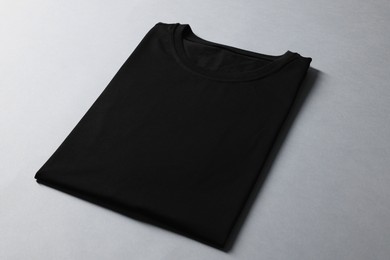 Photo of Blank black t-shirt on grey background. Mockup for design