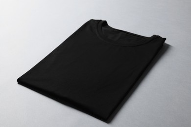 Photo of Blank black t-shirt on grey background. Mockup for design