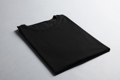 Photo of Blank black t-shirt on grey background. Mockup for design