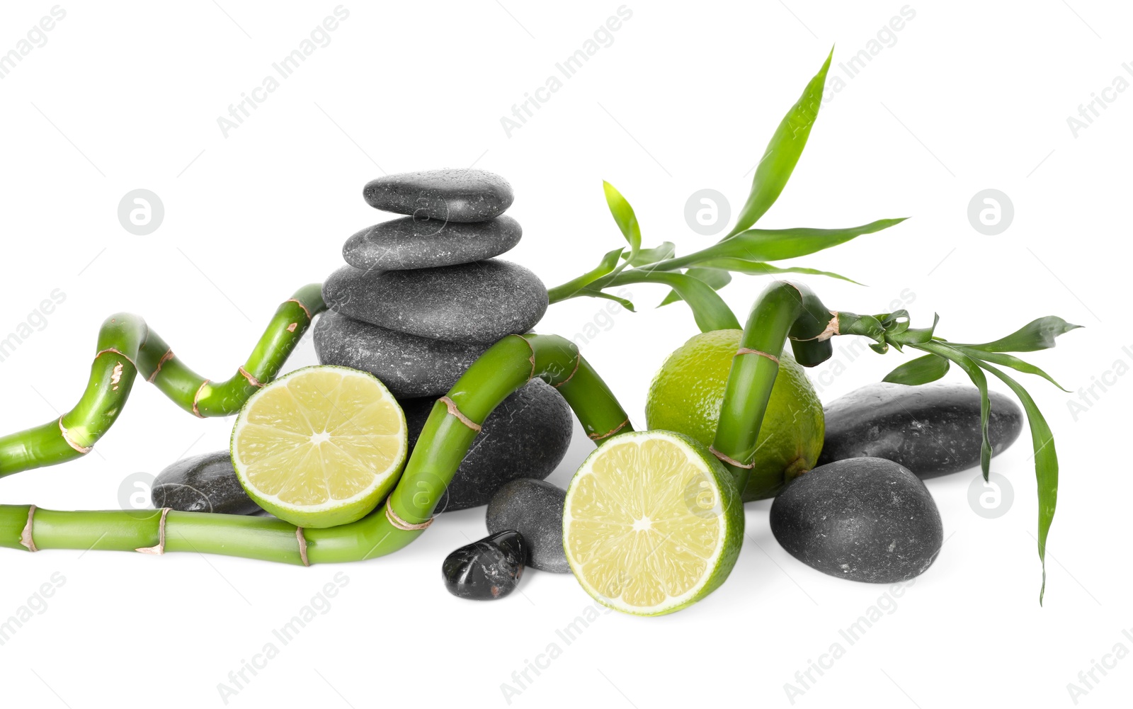 Spa composition with limes, massage stones and bamboo stems isolated on white Photo of Spa composition with limes, massage stones and bamboo stems isolated on white
