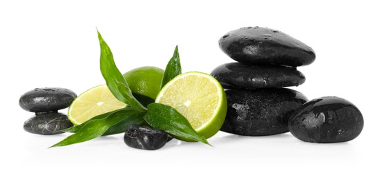 Photo of Spa composition with limes, massage stones and green leaves on mirror surface against white background