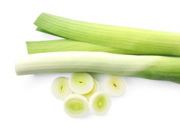 Photo of Whole and cut leeks isolated on white, top view