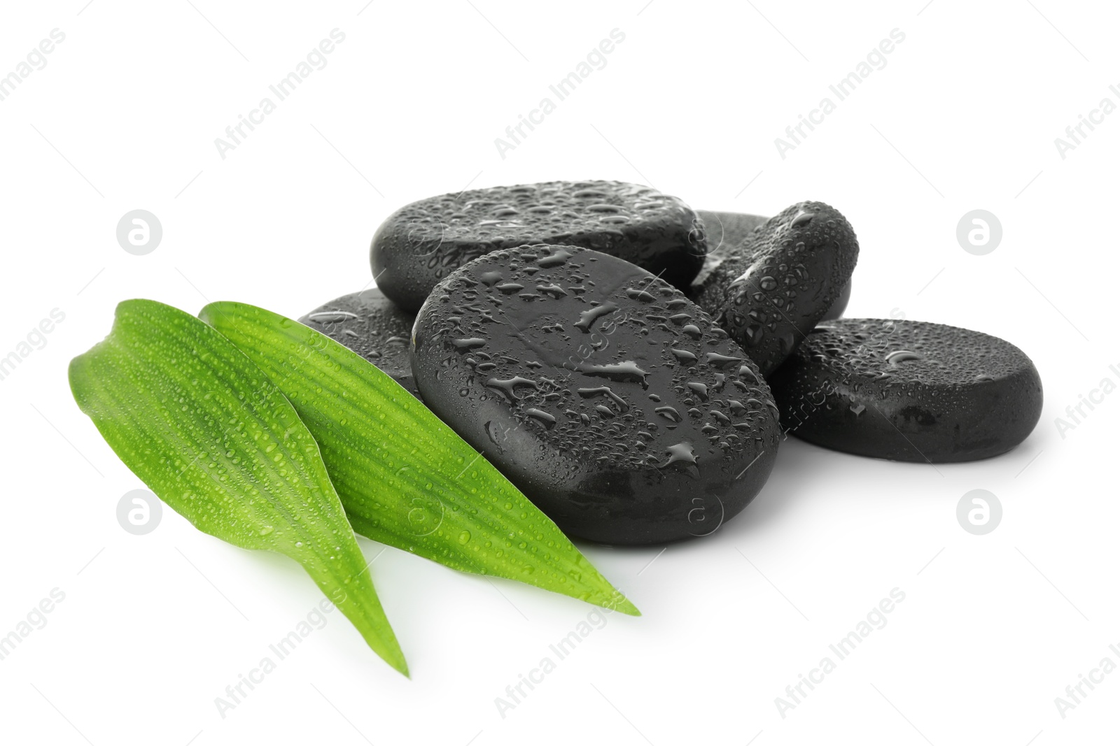 Photo of Wet spa stones with leaves isolated on white