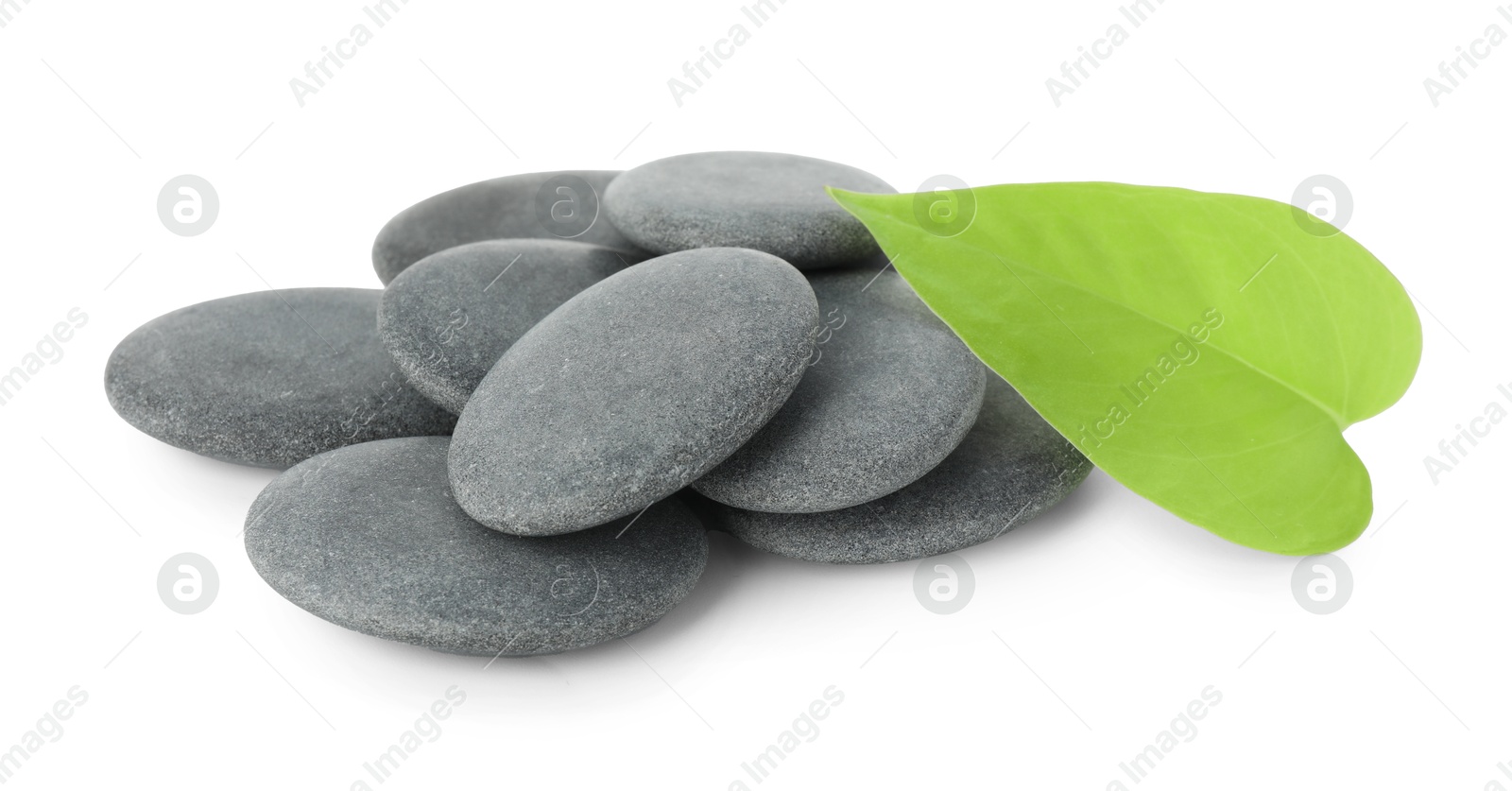 Photo of Spa stones with leaf isolated on white