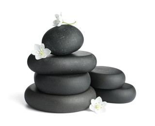 Photo of Stacked spa stones and beautiful flowers isolated on white