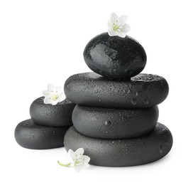 Photo of Stacked spa stones and beautiful flowers isolated on white