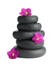 Photo of Stacked spa stones and beautiful flowers isolated on white