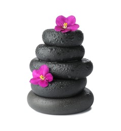 Photo of Stacked spa stones and beautiful flowers isolated on white