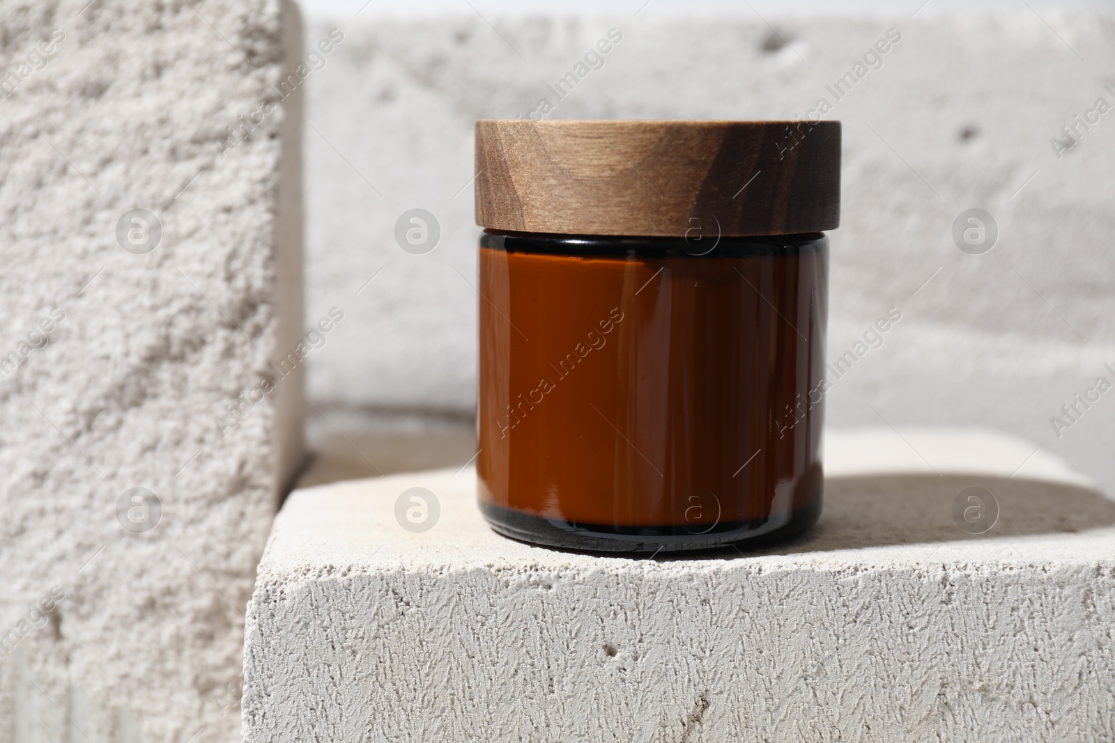 Photo of One jar of cream on concrete block