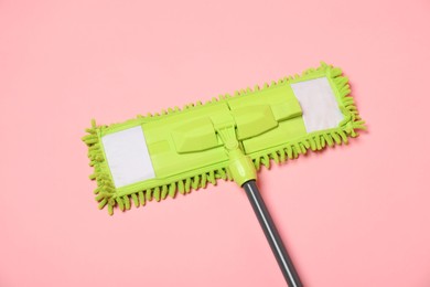 Photo of Microfiber mop on pink background, above view