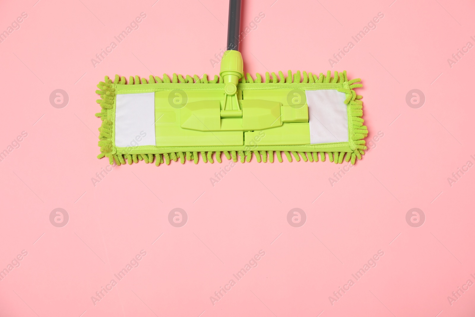 Photo of Microfiber mop on pink background, top view. space for text