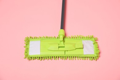 Photo of Microfiber mop on pink background, above view