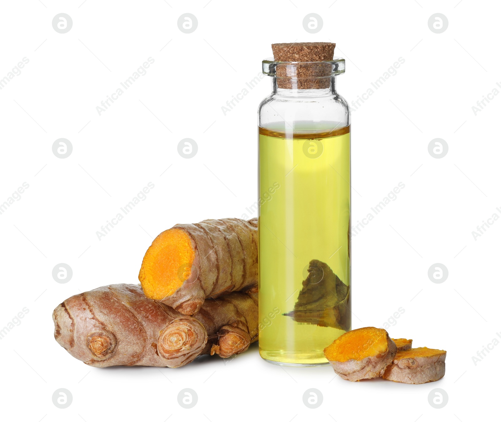 Photo of Bottle of turmeric essential oil and raw roots isolated on white