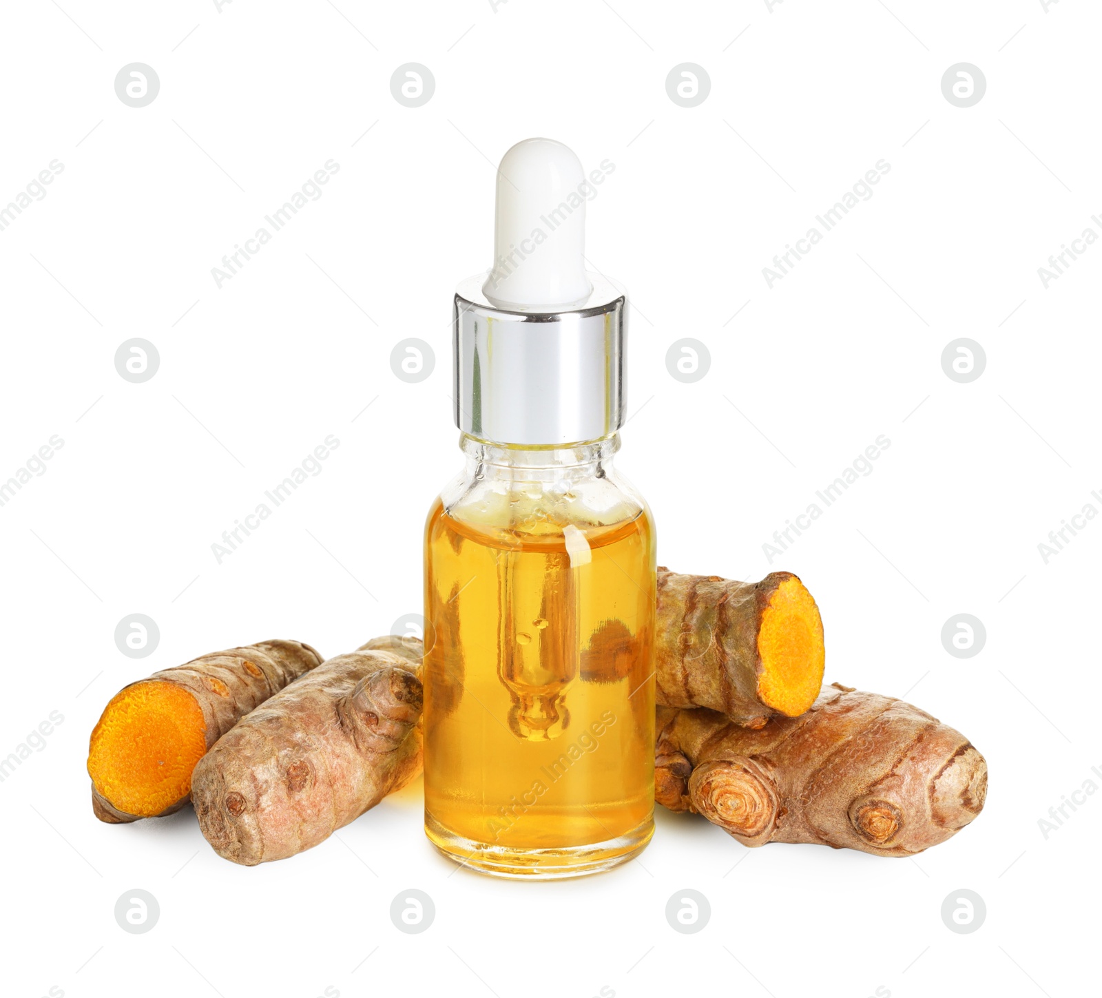 Photo of Bottle of turmeric essential oil and raw roots isolated on white