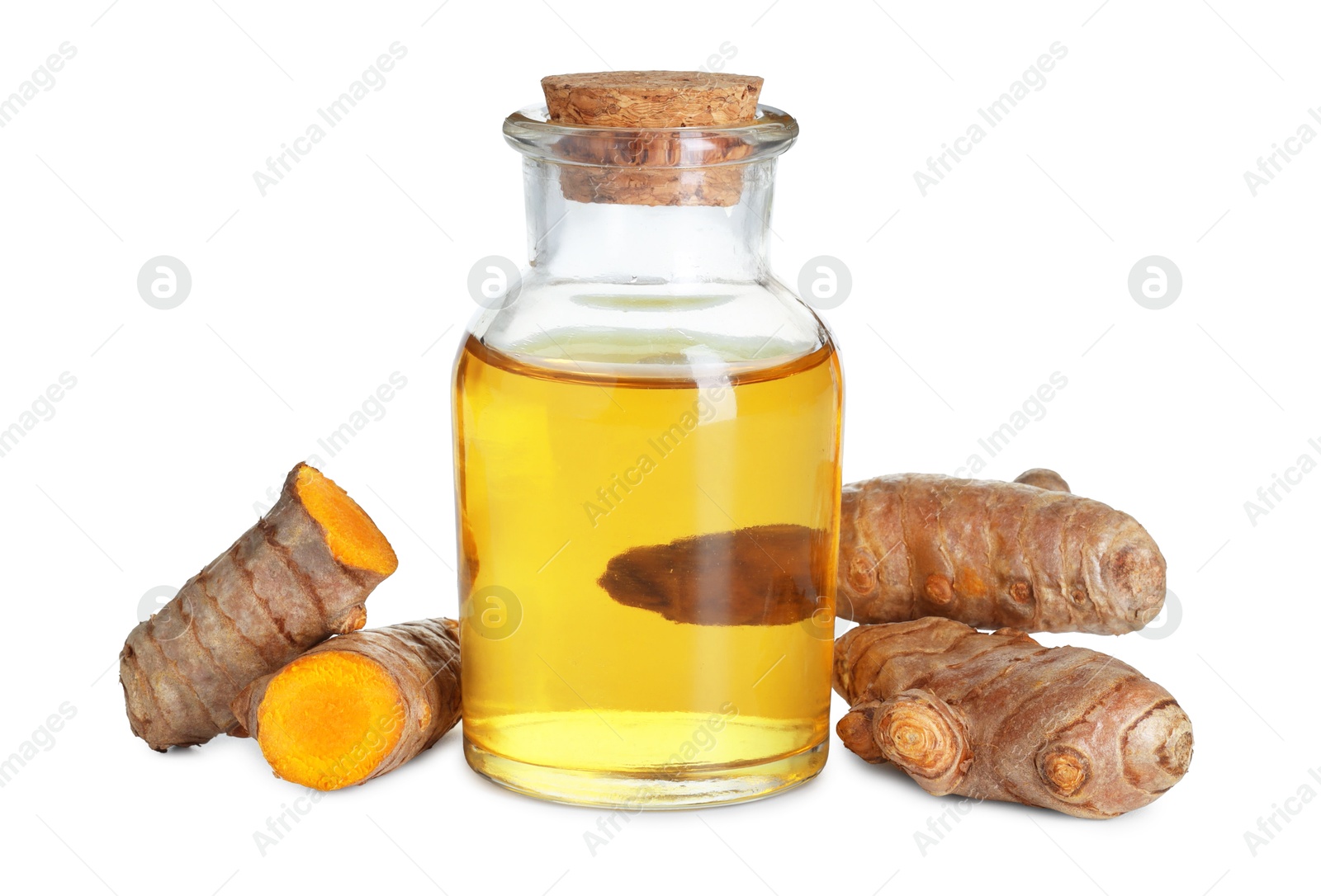 Photo of Bottle of turmeric essential oil and raw roots isolated on white