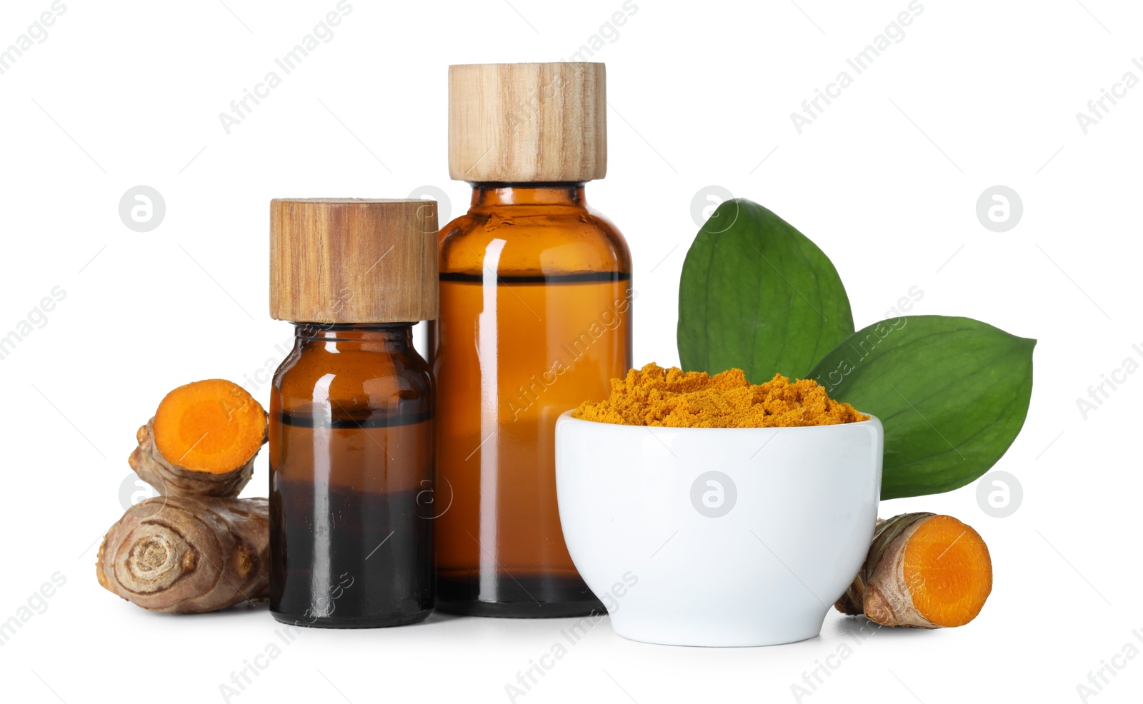 Photo of Bottles of turmeric essential oil, powder, raw roots and leaves isolated on white