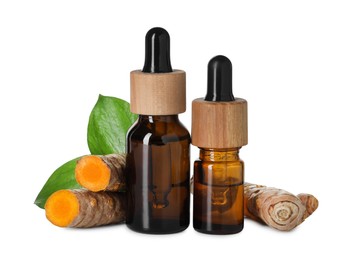 Photo of Bottles of turmeric essential oil, raw roots and leaves isolated on white