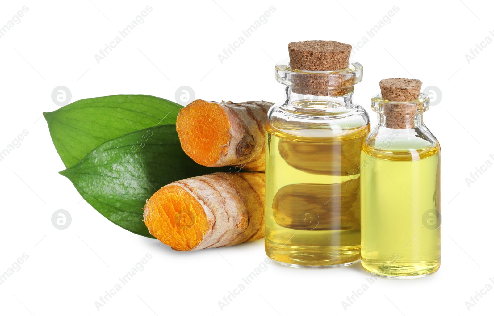 Photo of Bottles of turmeric essential oil, raw roots and leaves isolated on white