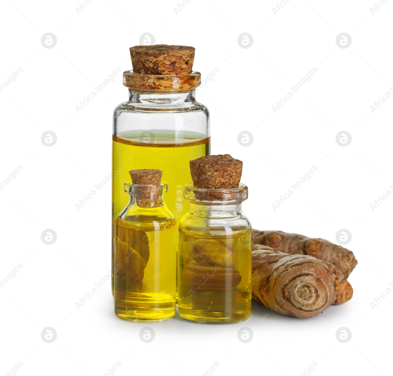 Photo of Bottles of turmeric essential oil and raw roots isolated on white