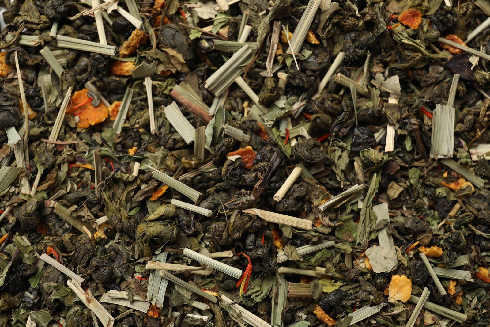 Photo of Pile of dry tea leaves as background, top view