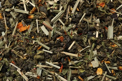 Photo of Pile of dry tea leaves as background, top view