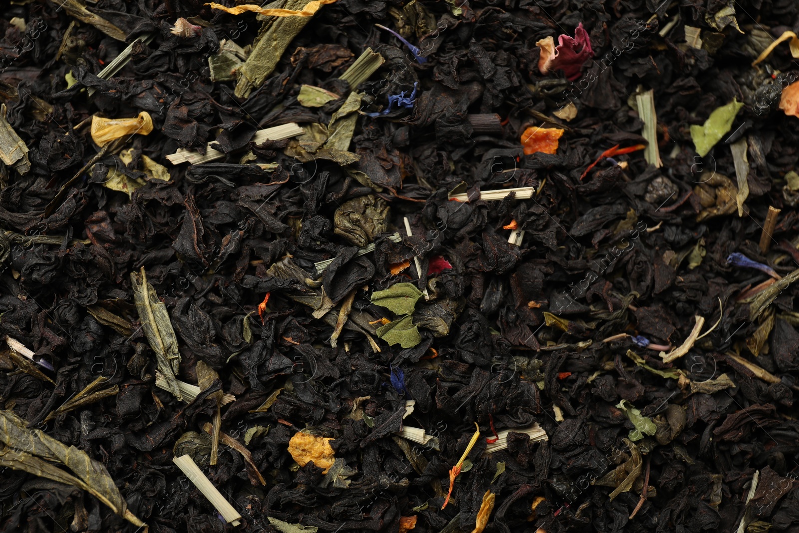 Photo of Pile of dry tea leaves as background, top view