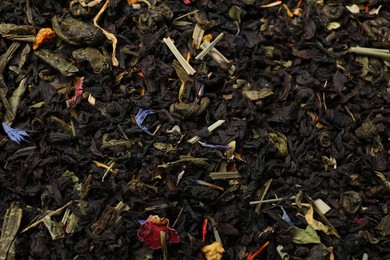 Photo of Pile of dry tea leaves as background, top view