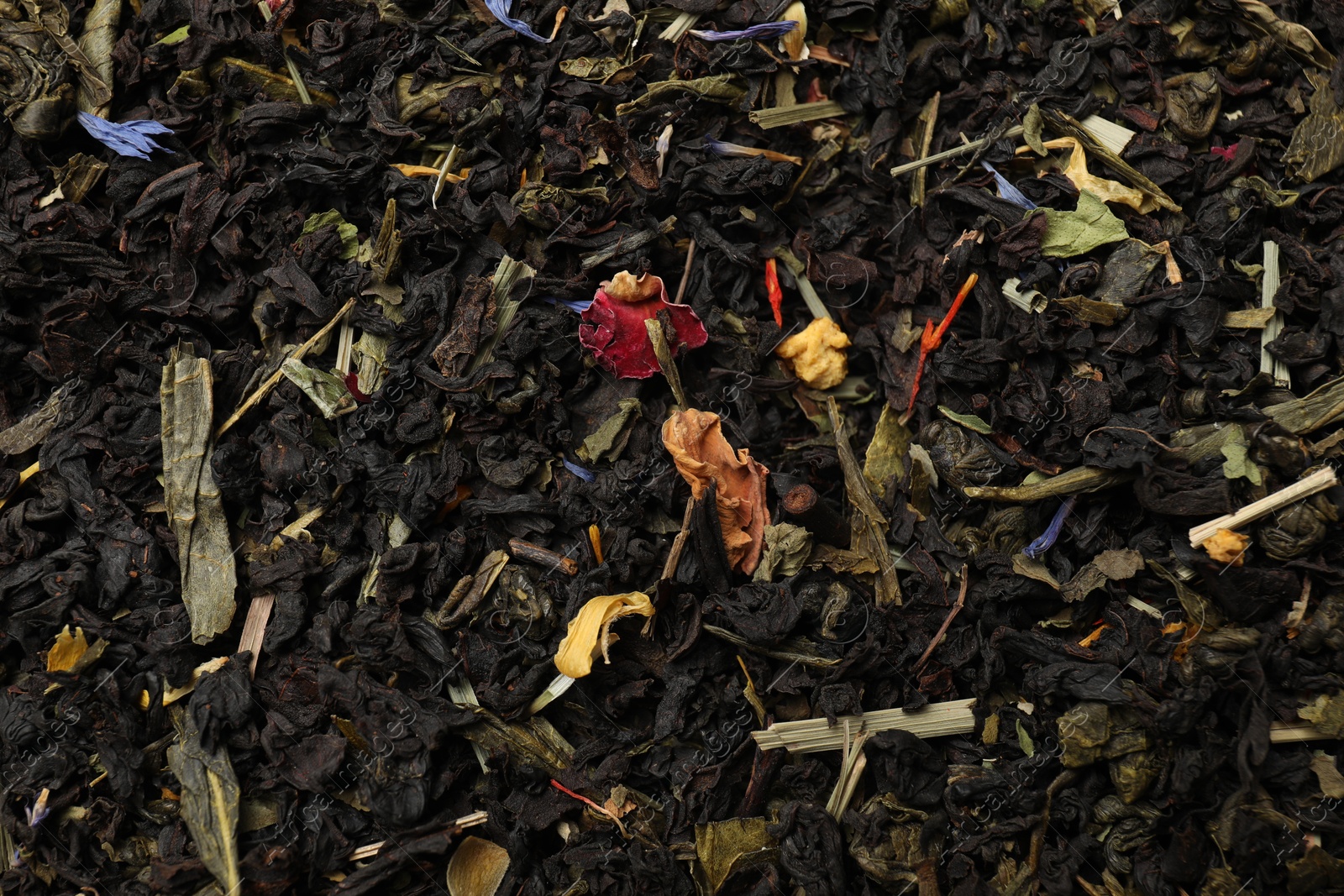 Photo of Pile of dry tea leaves as background, top view