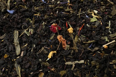 Photo of Pile of dry tea leaves as background, top view