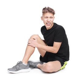 Photo of Young man suffering from pain in knee on white background