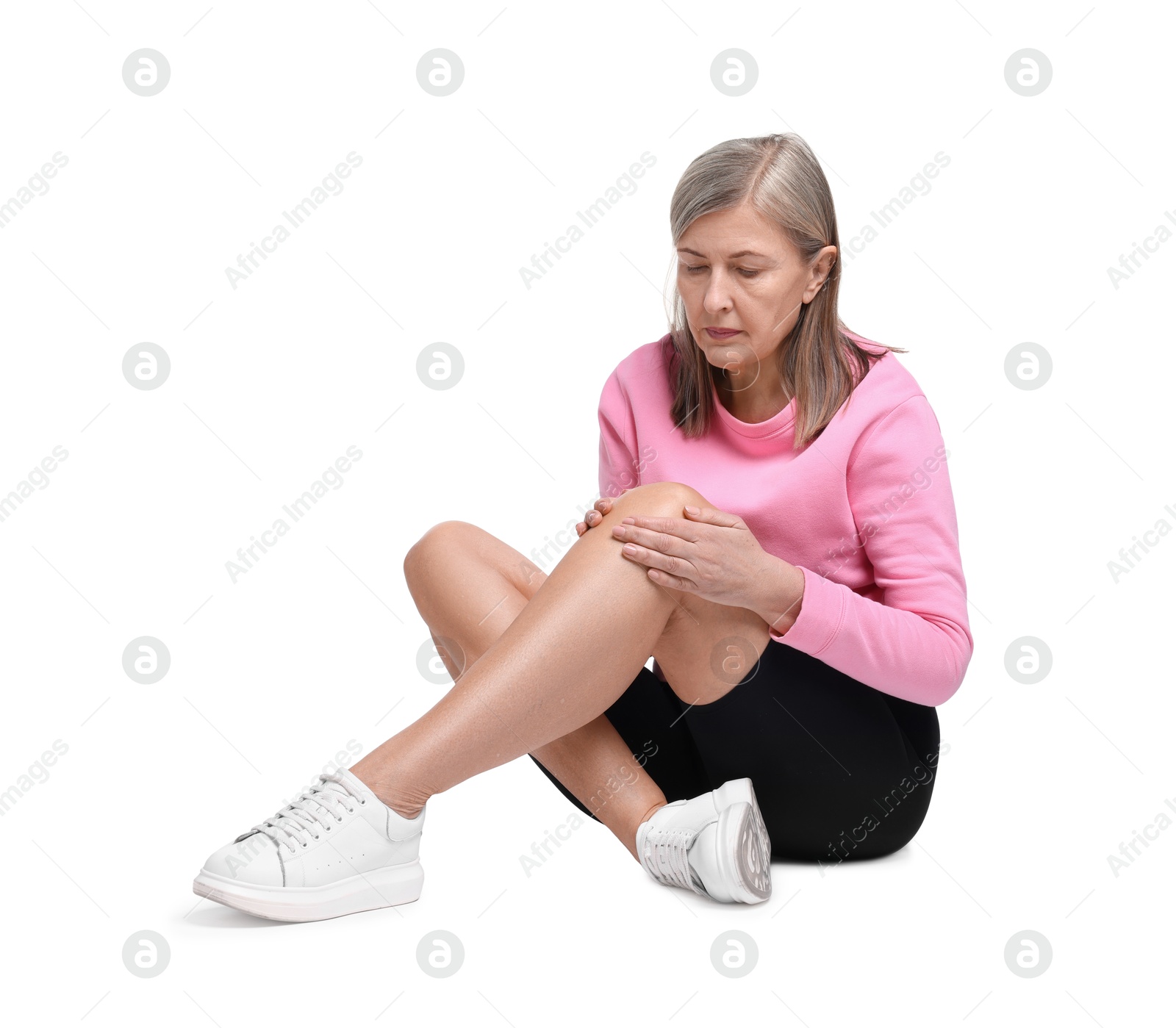 Photo of Senior woman suffering from knee pain on white background