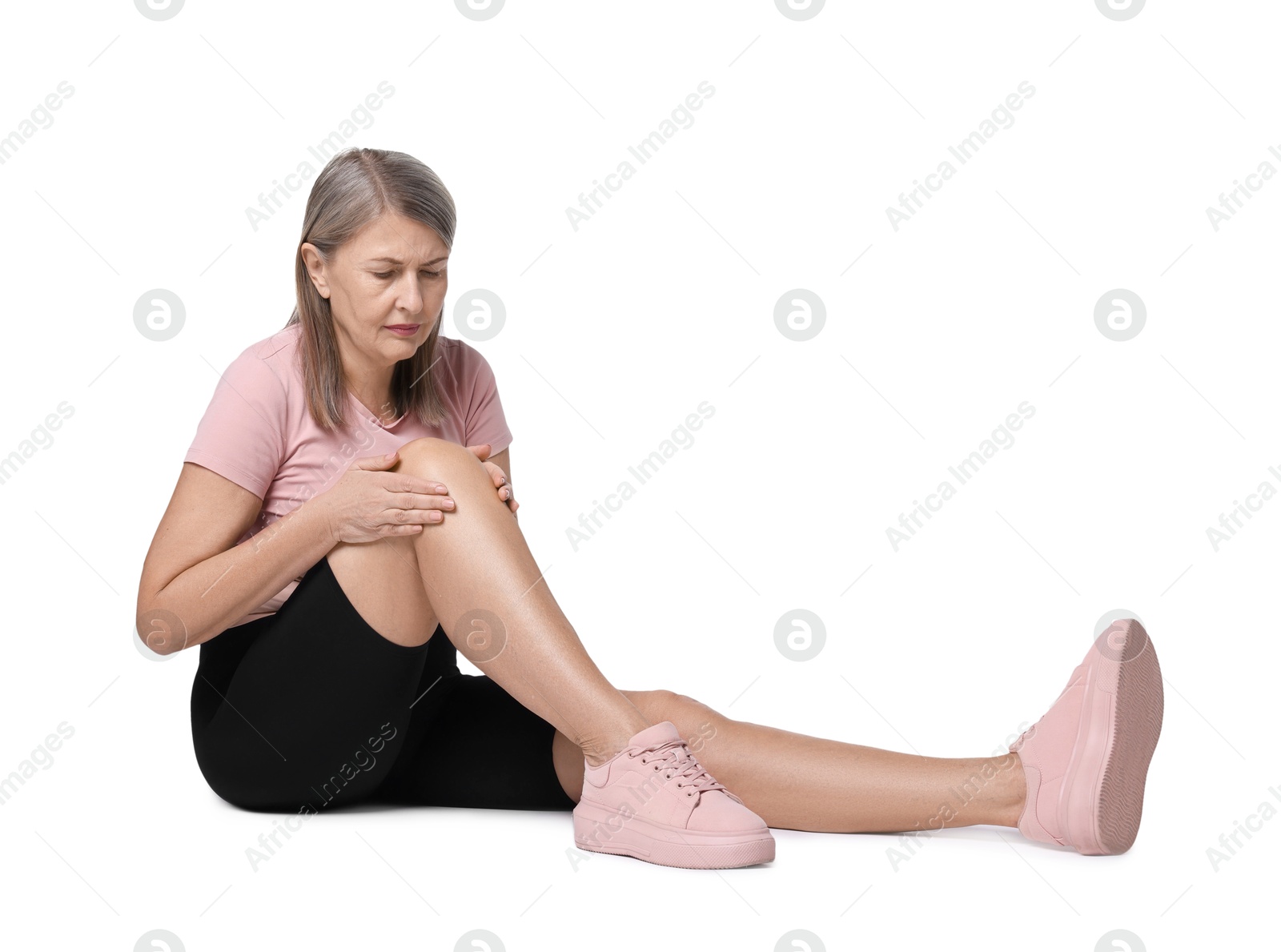 Photo of Senior woman suffering from knee pain on white background