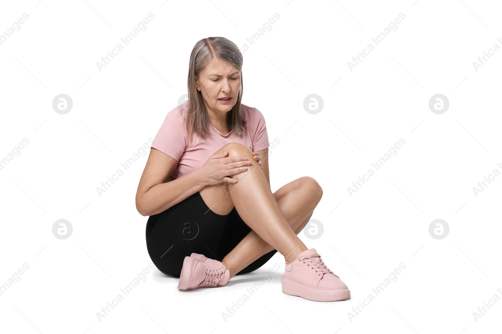 Photo of Senior woman suffering from knee pain on white background