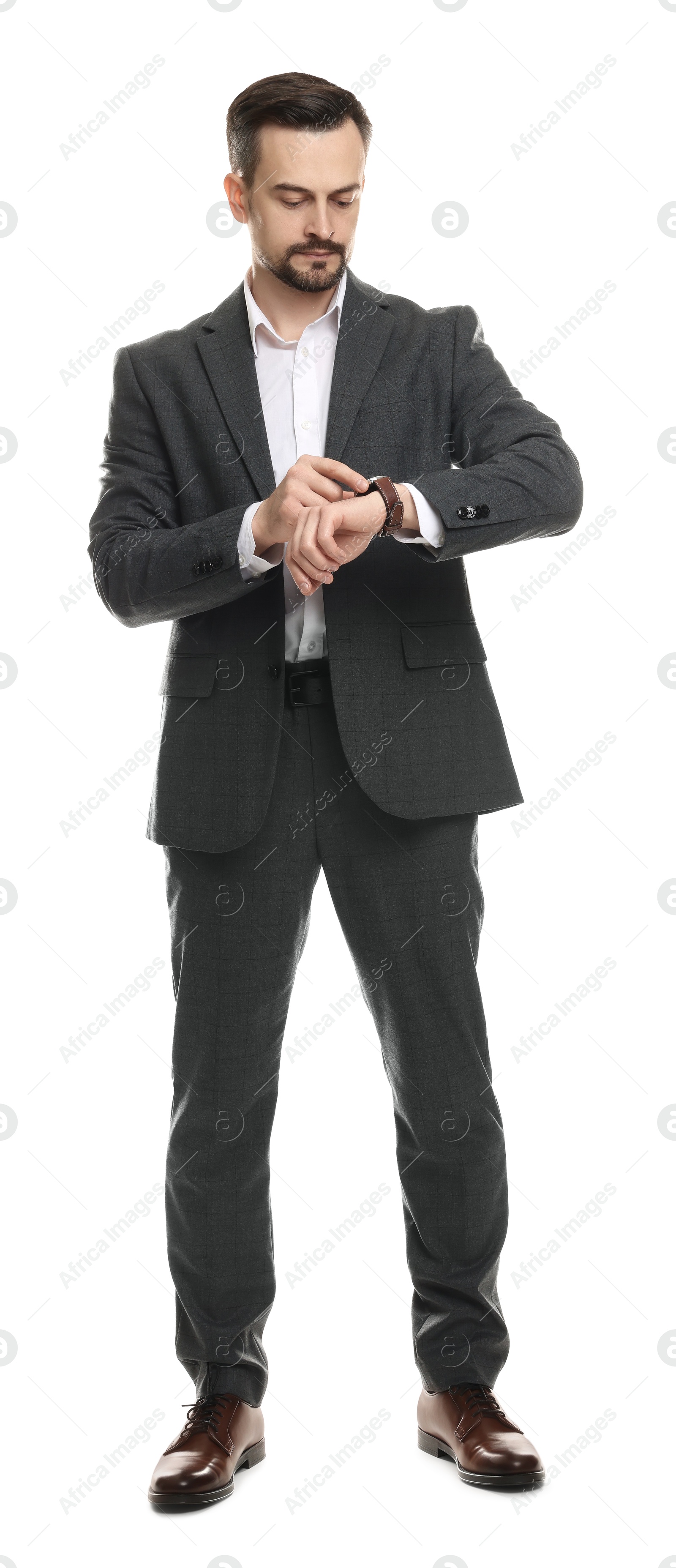 Photo of Confident man in classic suit checking time on white background