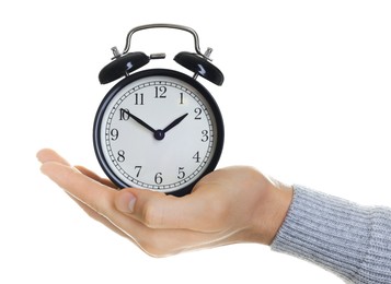 Man with black alarm clock on white background, closeup