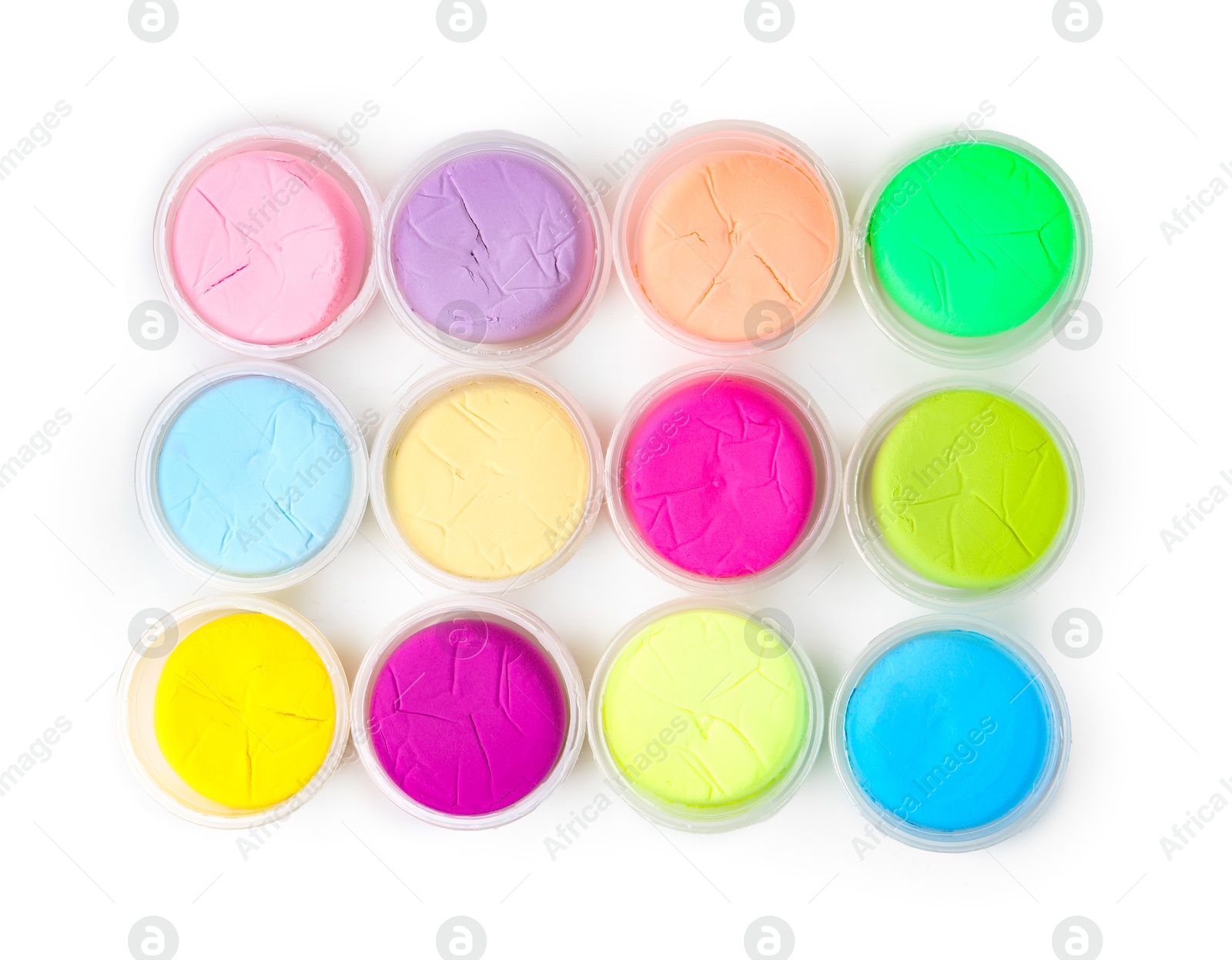 Photo of Different colorful modeling clay in plastic jars isolated on white, top view