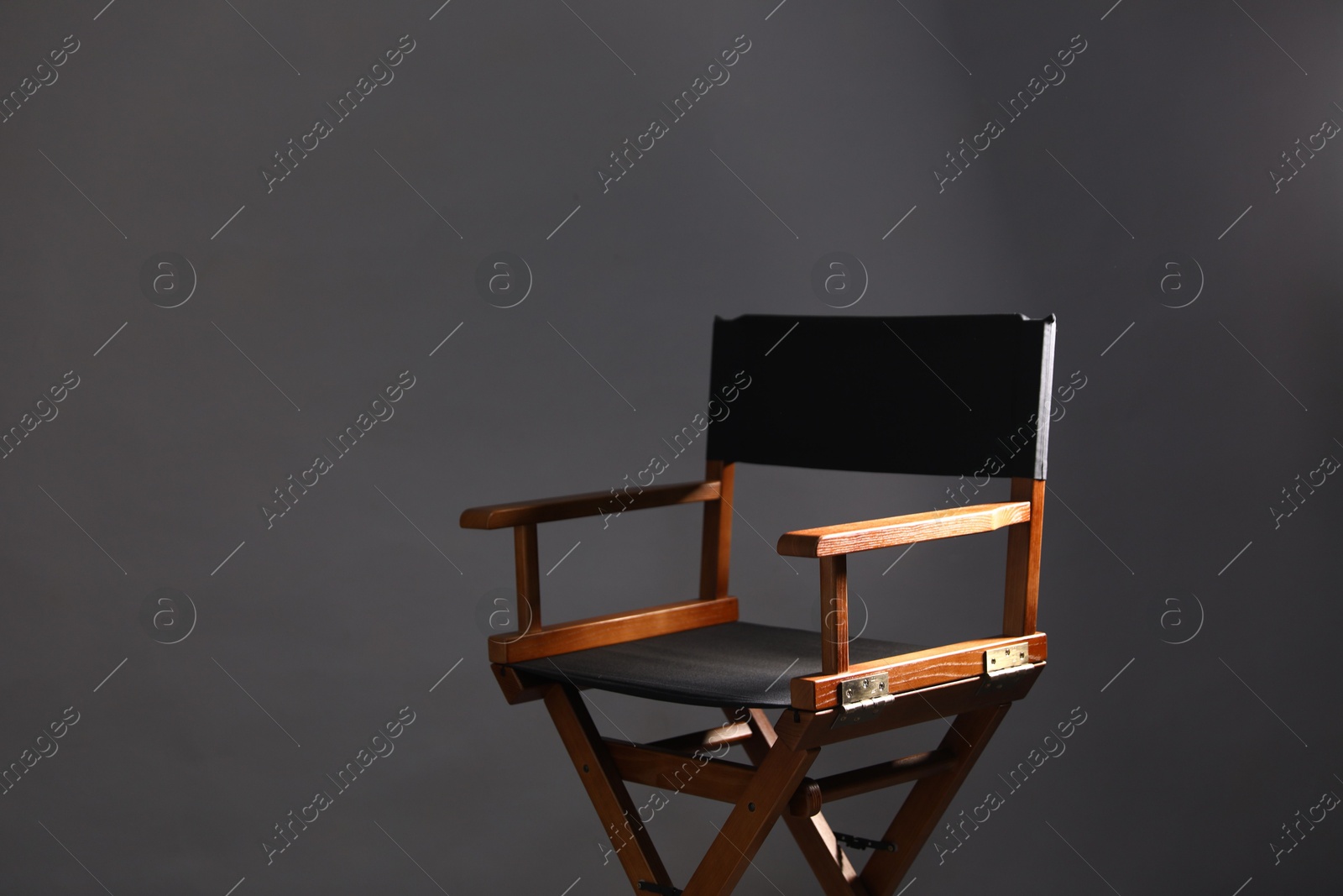 Photo of One empty director's chair on grey background, space for text