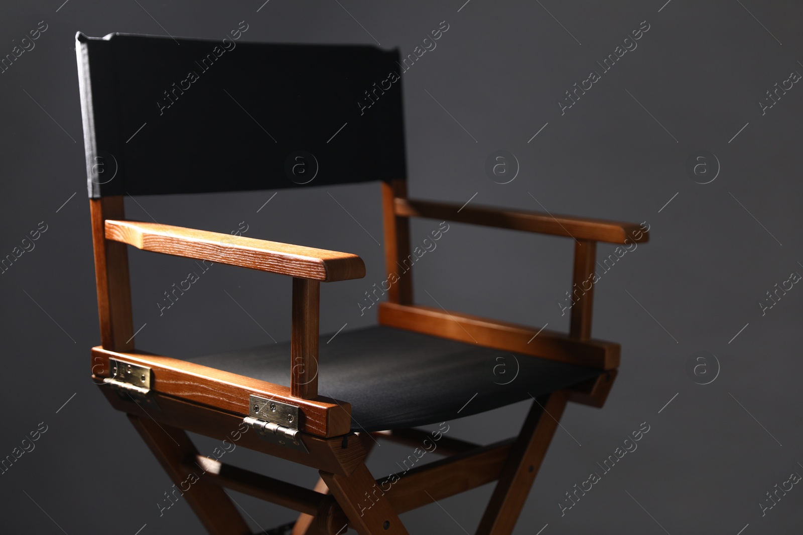 Photo of One empty director's chair on grey background, closeup