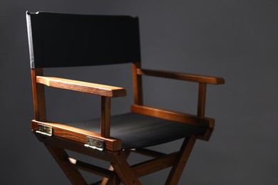 Photo of One empty director's chair on grey background, closeup