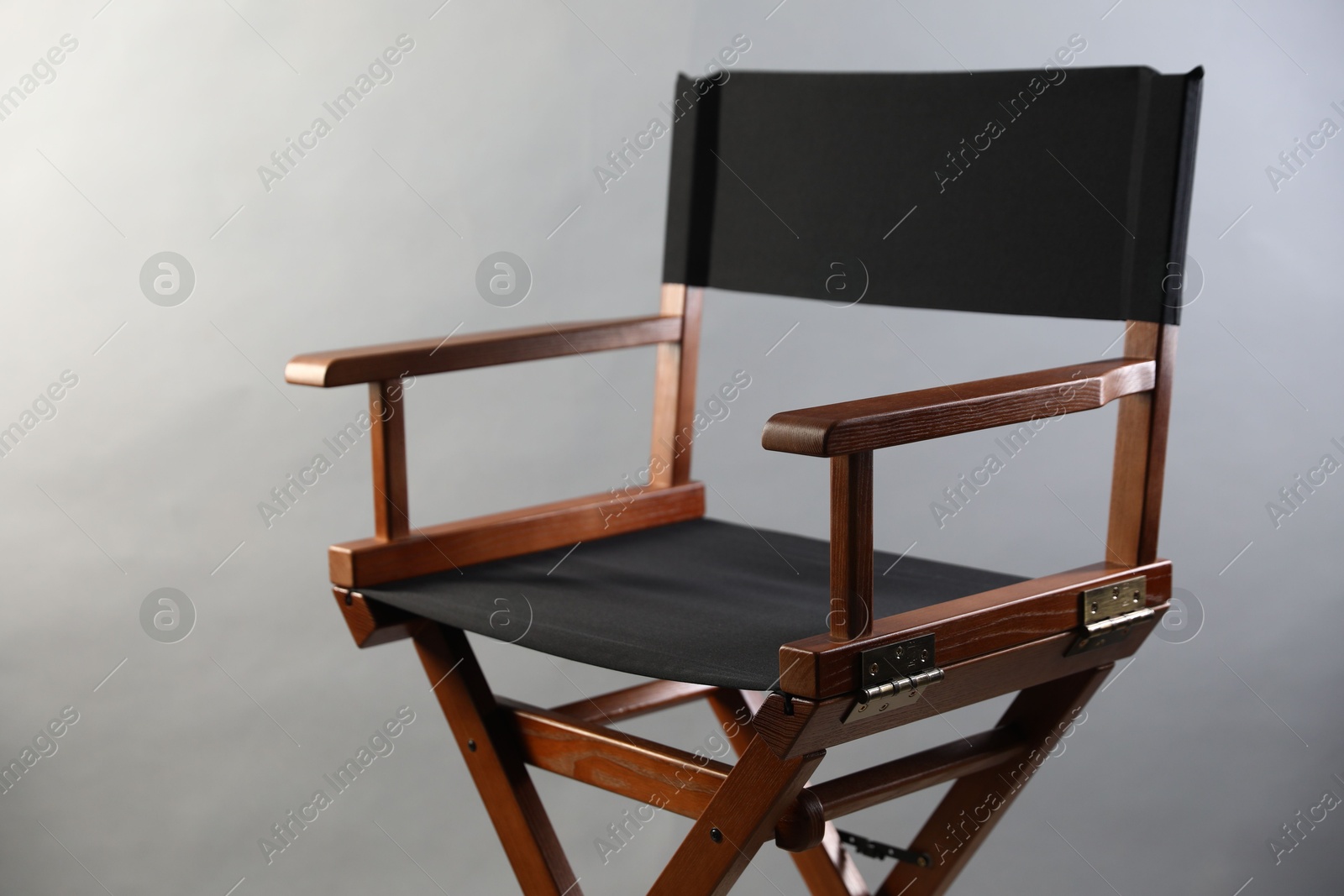 Photo of One empty director's chair on light grey background, closeup