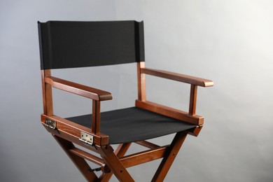 Photo of One empty director's chair on light grey background, closeup