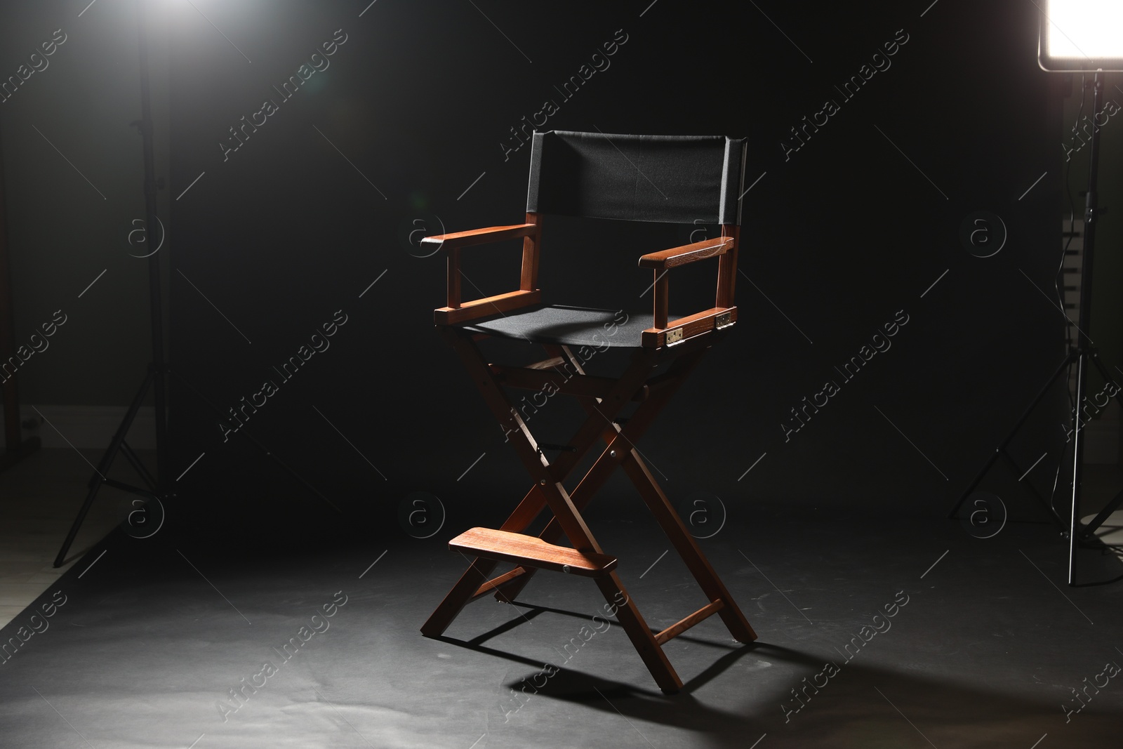 Photo of One empty director's chair on black background