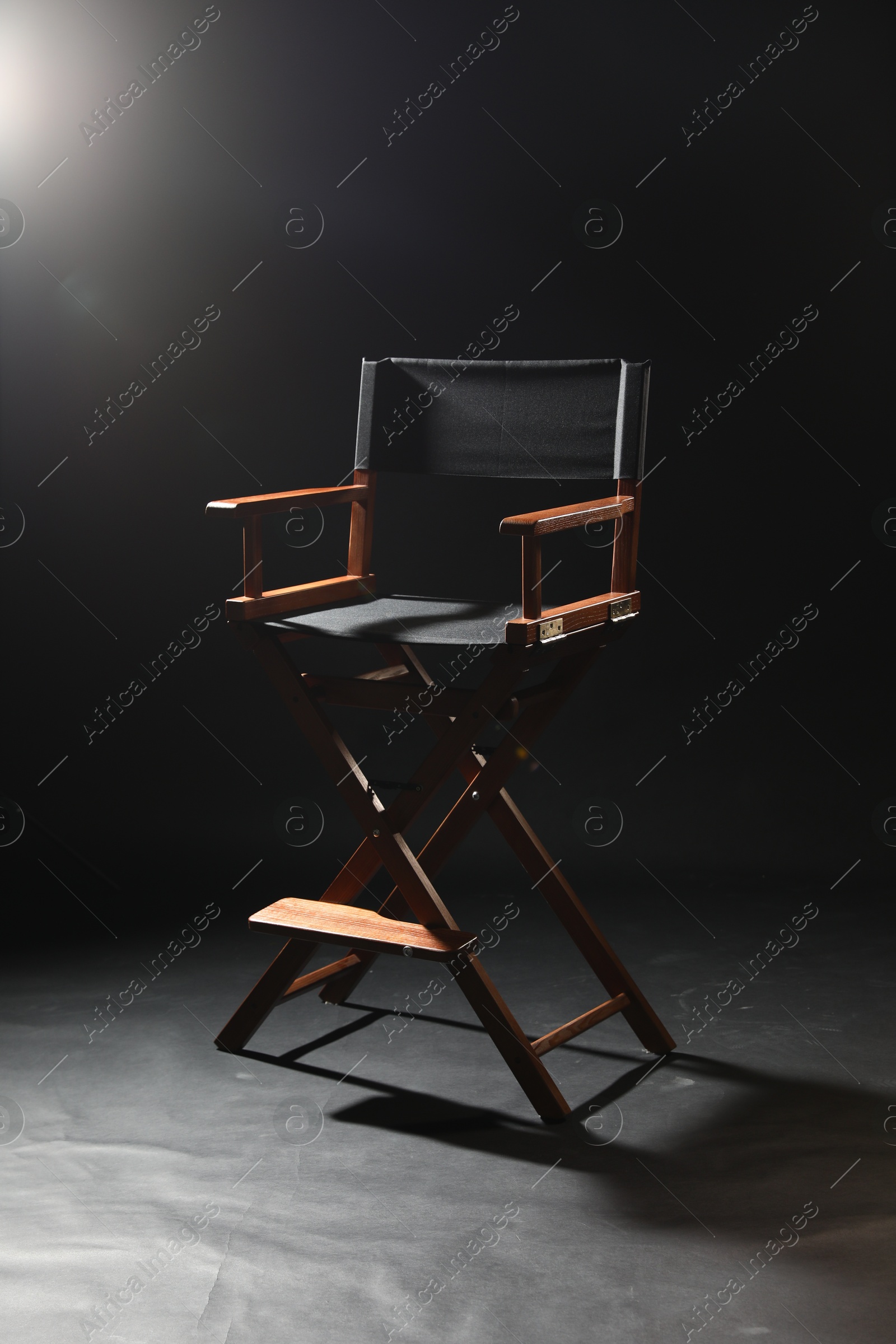 Photo of One empty director's chair on black background