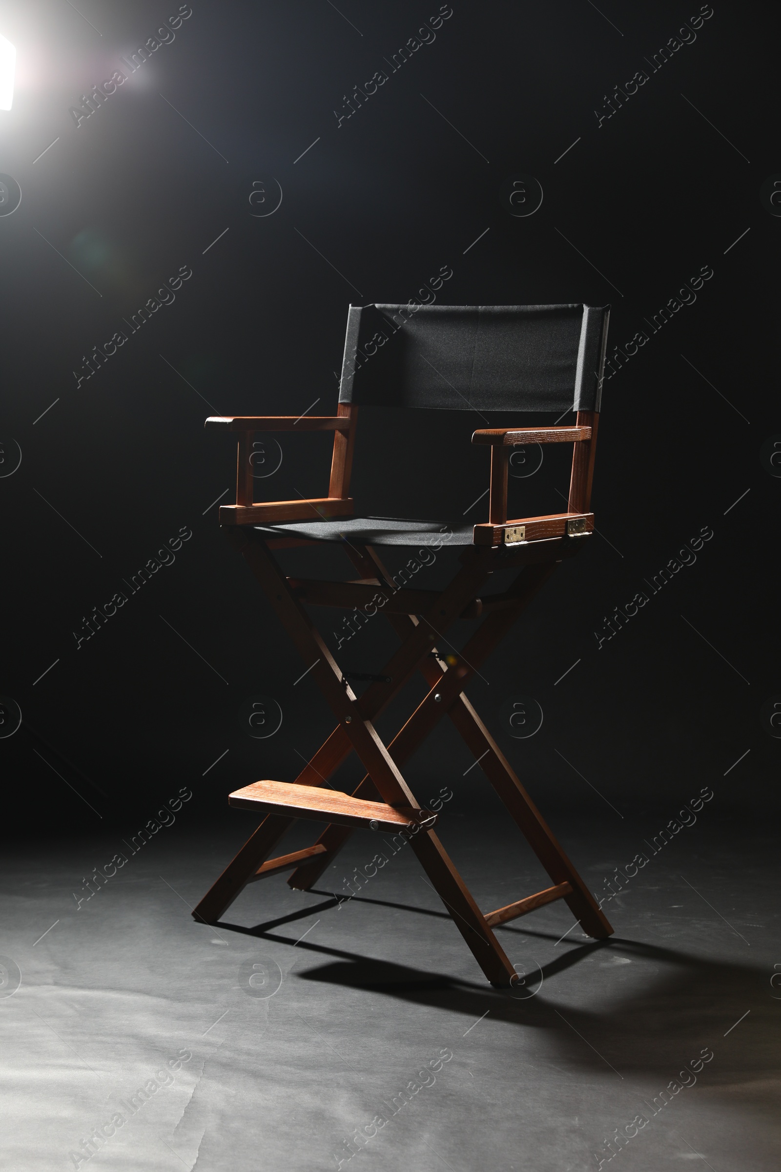 Photo of One empty director's chair on black background